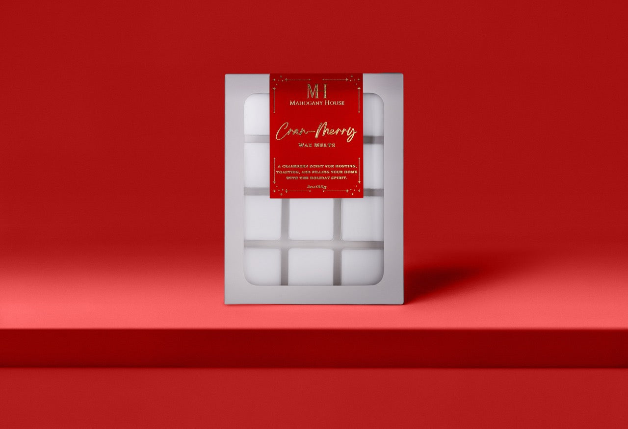 Mahogany House Cran-Merry wax melts with cranberry, mandarin and rosemary and juniper in green holiday packaging.