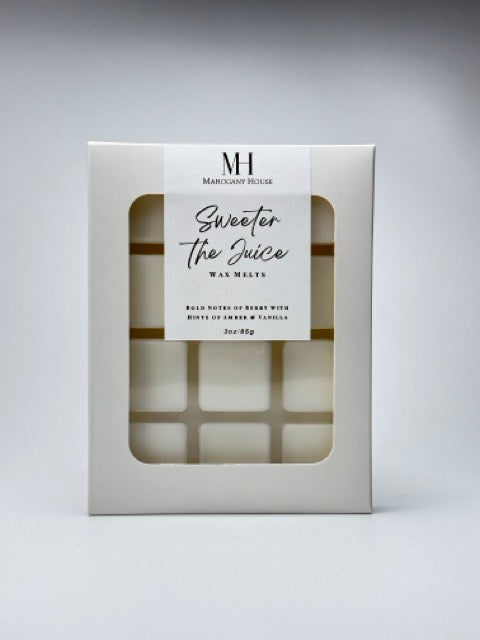 Close-up of Sweeter The Juice black cherry wax melts clamshell with Mahogany House label on a clean white background.