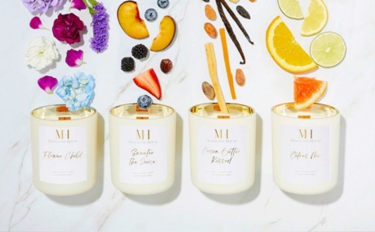 Four Mahogany House wooden wick candles from the Core Collection, shown with fragrance ingredients: florals, berries, vanilla, and citrus.