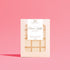 Mahogany House Flower Child Wax Melts displayed at a wide angle on a pink backdrop, highlighting the grid of wax squares inside the packaging.