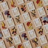 Flat lay of multiple Mahogany House Flower Child Wax Melt packs arranged neatly, emphasizing luxury branding and consistency.