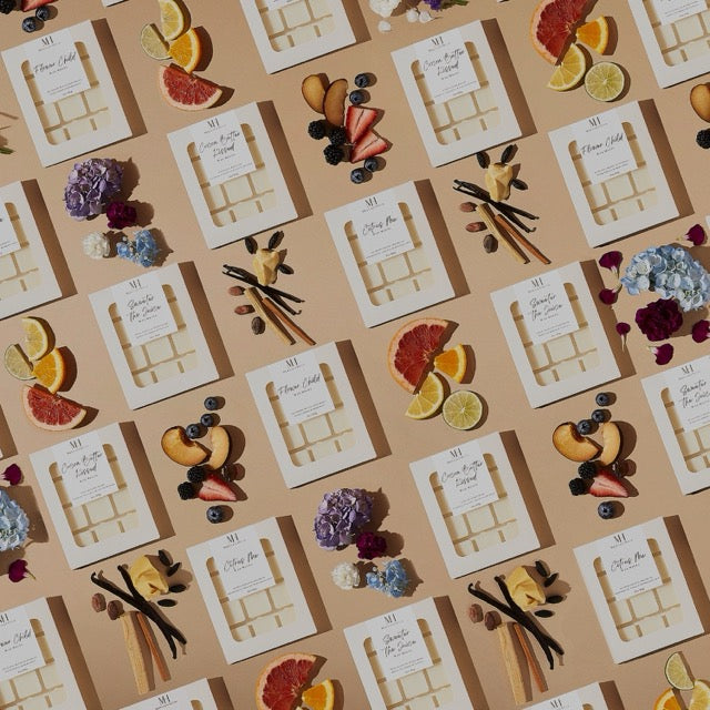 Flat lay of multiple Mahogany House Flower Child Wax Melt packs arranged neatly, emphasizing luxury branding and consistency.