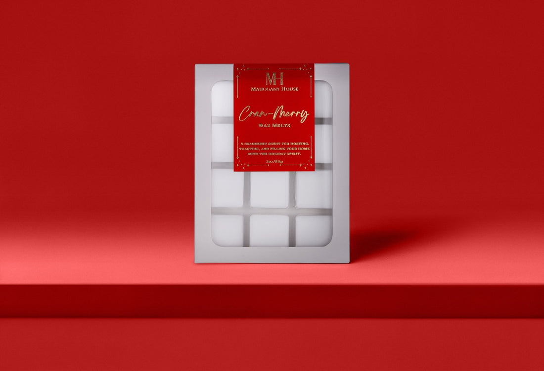 Mahogany House Cran-Merry wax melts with cranberry, mandarin and rosemary and juniper in green holiday packaging.