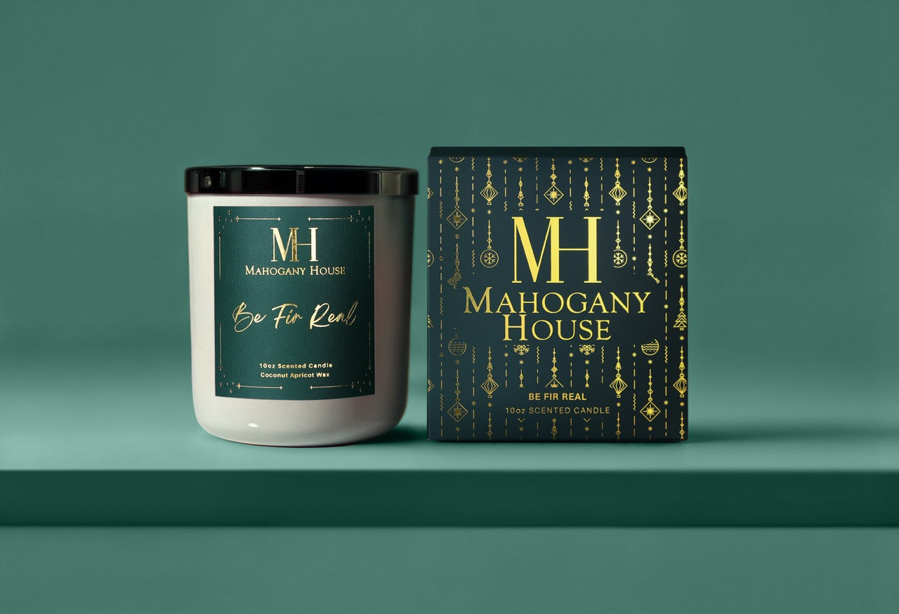 Candle and packaging of Mahogany House Be Fir Real Candle  on a teal background