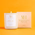 Mahogany House Citrus Me Candle in a white jar with a soft pink and gold gift box, hand-poured with coconut wax and featuring a crackling wood wick. This luxury scented candle highlights refreshing citrus notes, perfect for energizing your space.