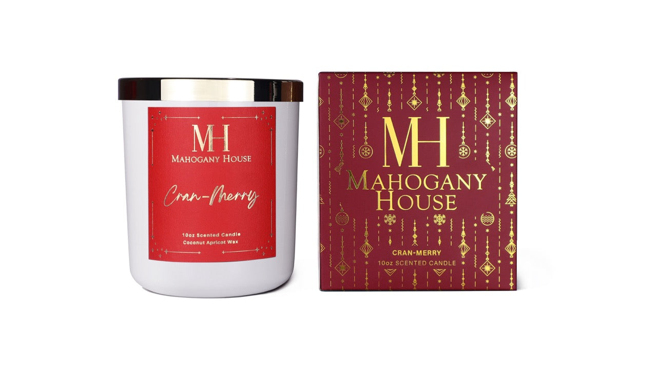 Mahogany House Cran-Merry candle with red holiday label and matching luxury gift box featuring gold ornament design