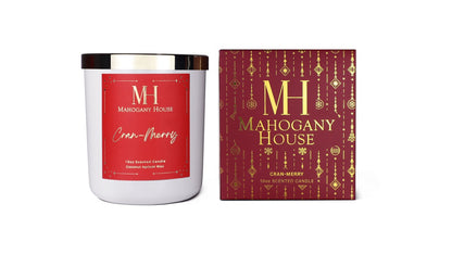 Mahogany House Cran-Merry candle with red holiday label and matching luxury gift box featuring gold ornament design