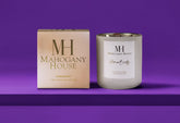 HomeBody votive candle in white glass vessel with Mahogany House packaging, 