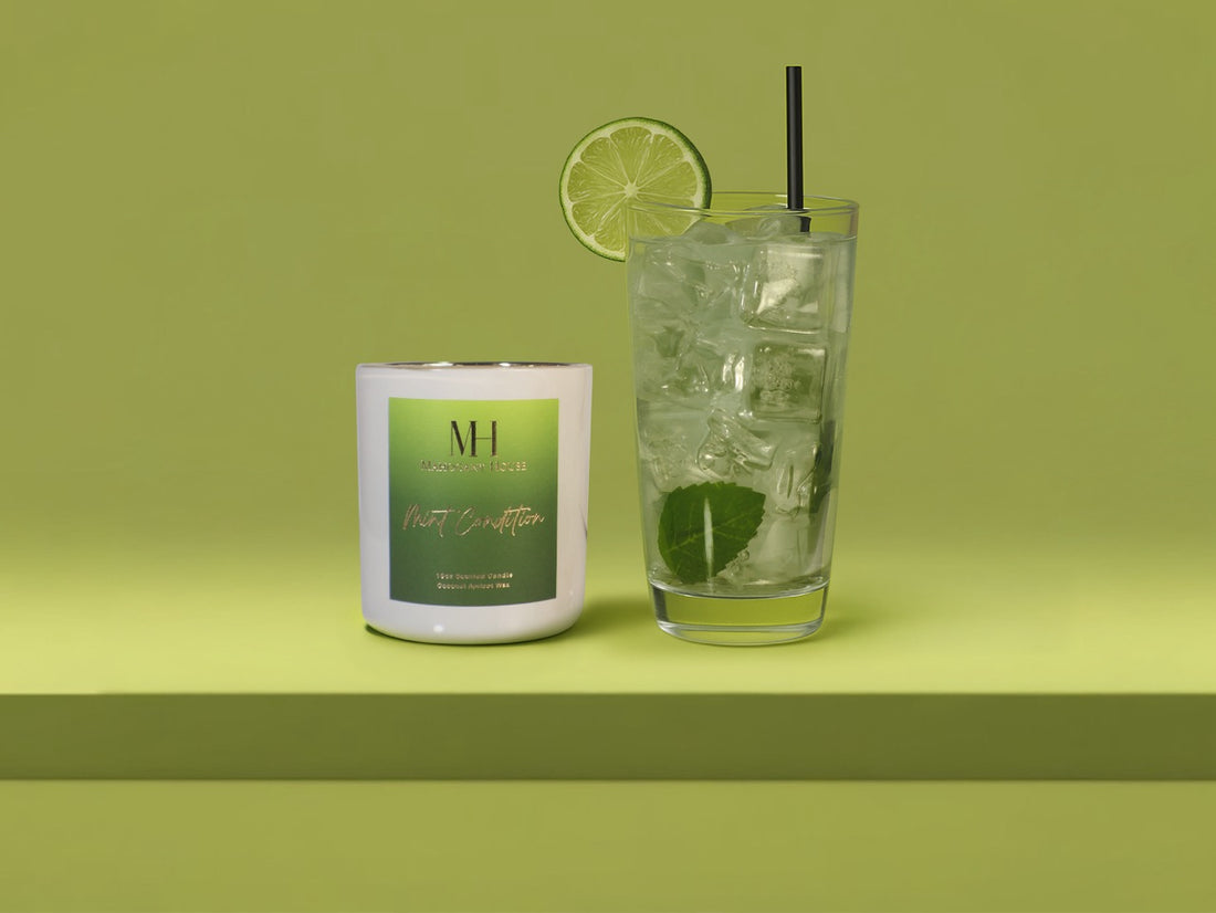 Mint Condition 10oz wooden wick candle styled with a cocktail glass, fresh lime garnish, and mint sprig on a green background.