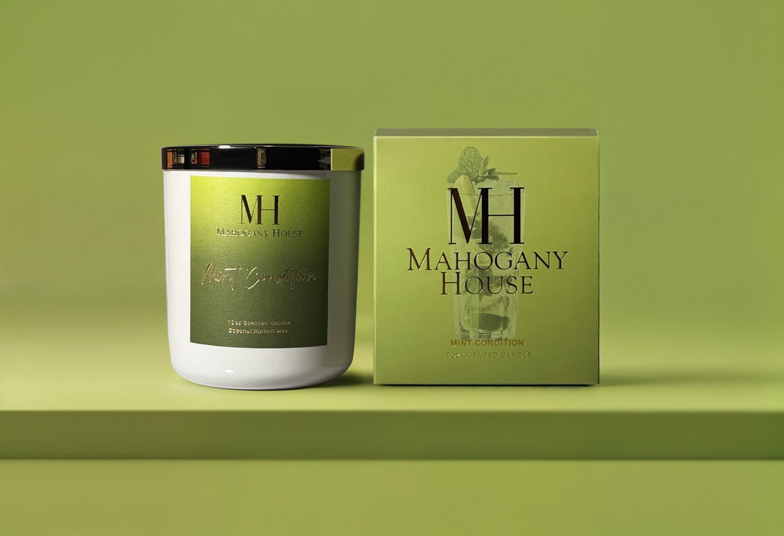 Mint Condition 10oz wooden wick candle in glossy cream glass vessel with green label, displayed beside Mahogany House packaging on a green background.