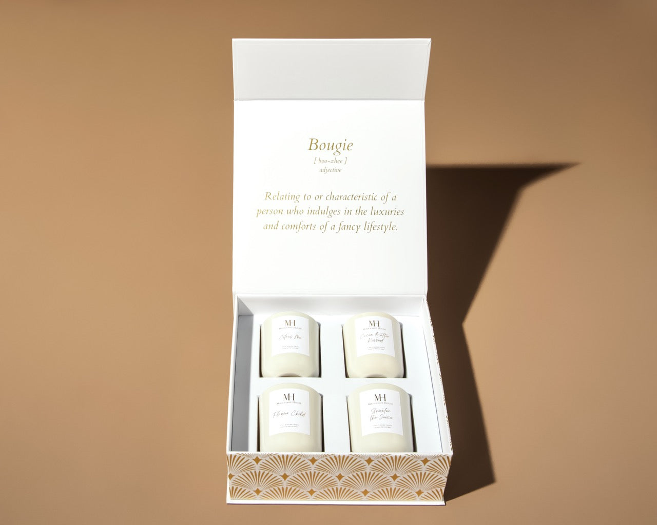 straight on shot of Mahogany House votive candle gift set with luxury Art Deco-inspired box packaging, featuring four signature scents and our definition of Bougie.