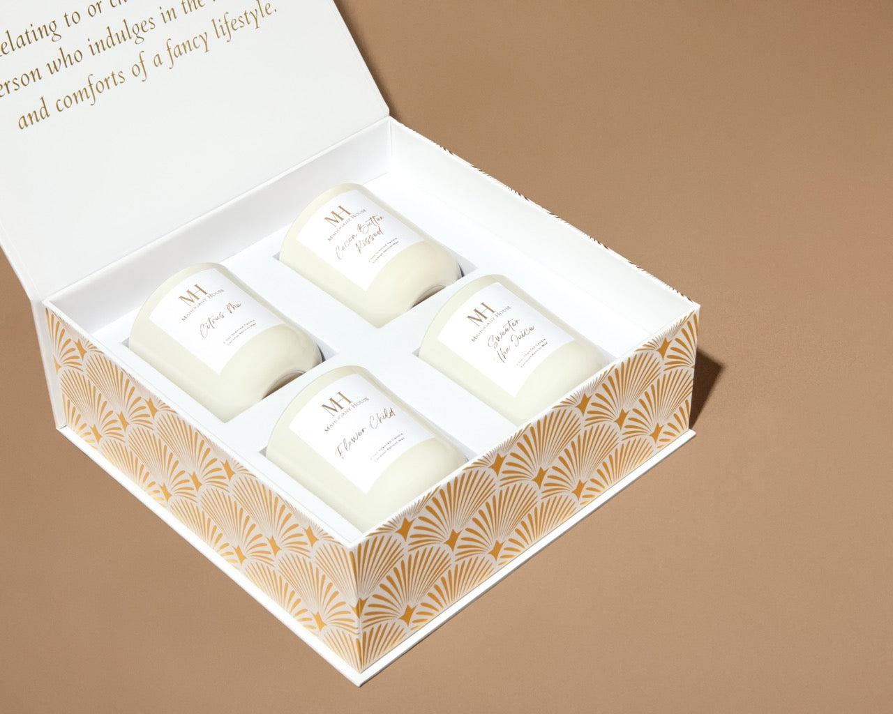 Close-up of Mahogany House votive candles neatly arranged inside the white magnetic-close gift box with lid open.