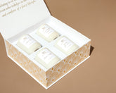 Close-up of Mahogany House votive candles neatly arranged inside the white magnetic-close gift box with lid open.