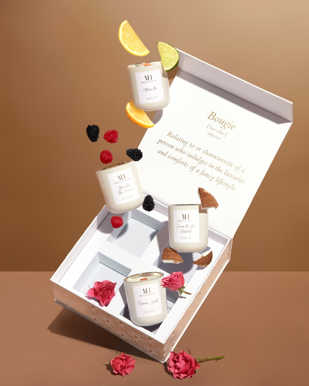 Open Mahogany House Votive Candle Gift Set displayed with four votives, surrounded by fruit and flowers for a luxury presentation.