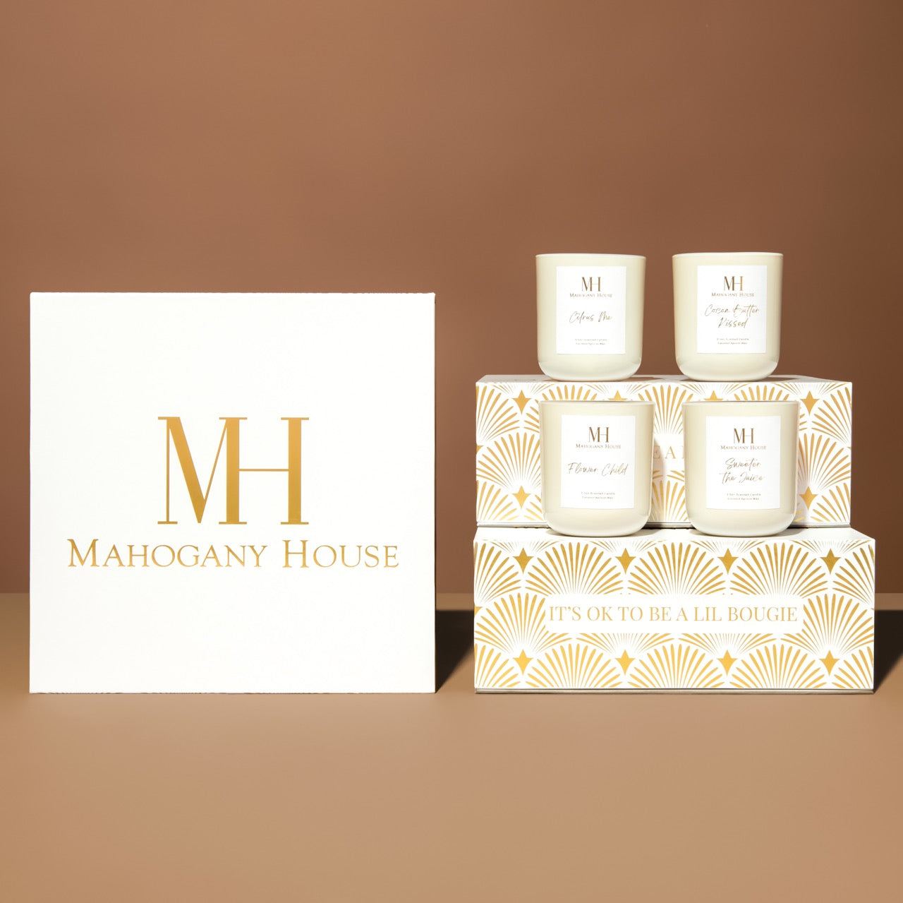 Closed Mahogany House luxury votive candle gift set with gold Art Deco design on the lid. and votive candles stacked in rows of 2